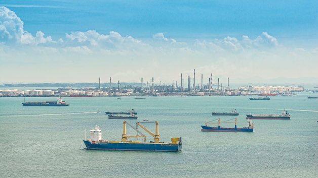 A port with various ships and bunker tankers